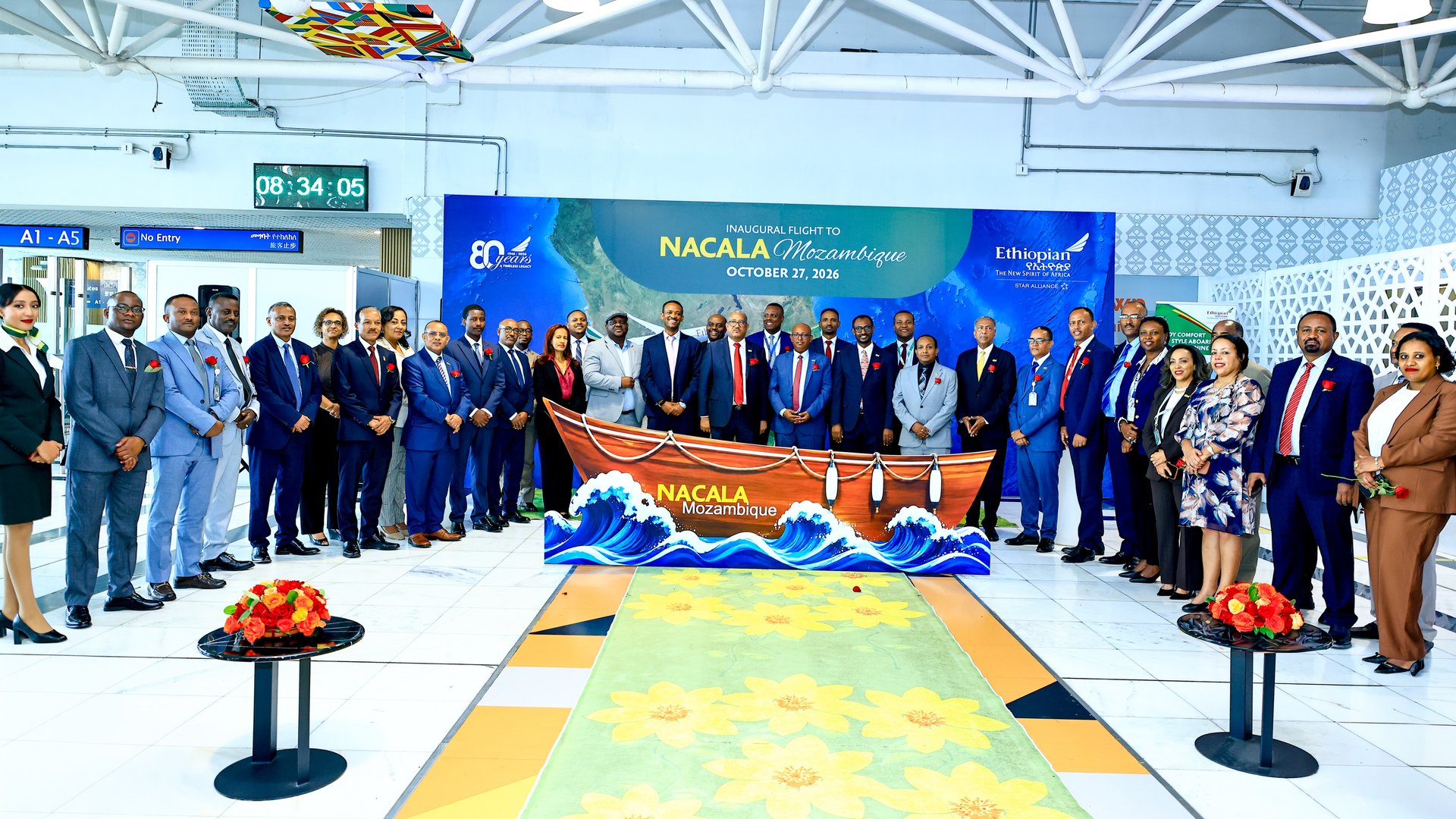 Ethiopian Airlines staff and guests pose at Addis Ababa Bole International Airport in front of a banner reading Inaugural Flight to Nacala Mozambique, October 27, 2026