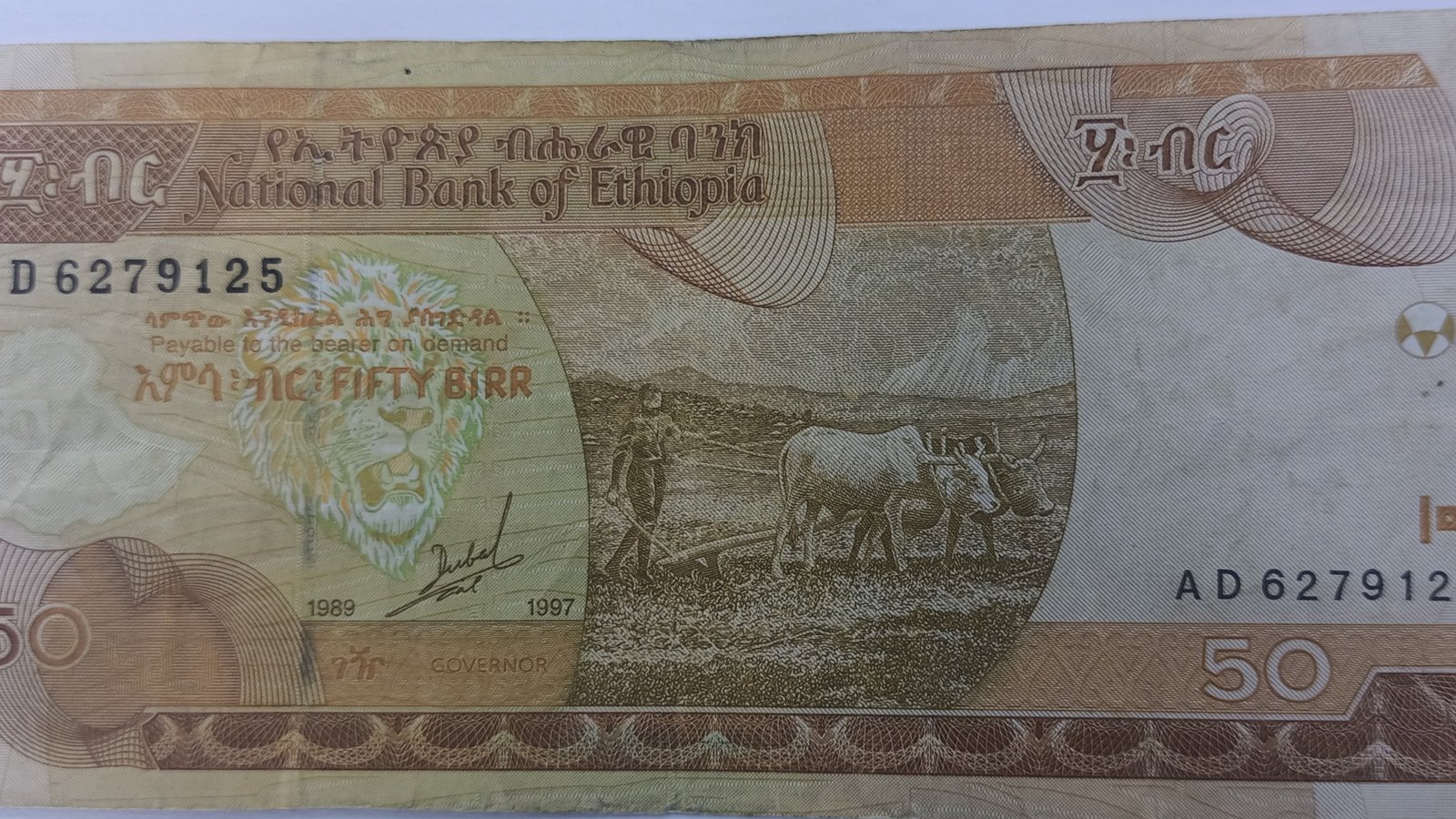 A fifty birr banknote from the National Bank of Ethiopia, showing a farmer ploughing with oxen